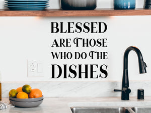Wall decals for kitchen that say ‘Blessed are those who do the dishes’ on a kitchen wall.
