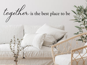 Living room wall decals that say ‘Together Is The Best Place To Be’ in a script font on a living room wall. 