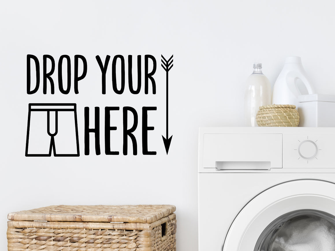 Laundry room wall decal that says ‘drop your drawers here’ on a laundry room wall.