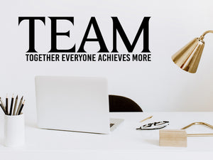 Wall decal for the office that says ‘TEAM Together Everyone Achieves More’ in a print font on an office wall.