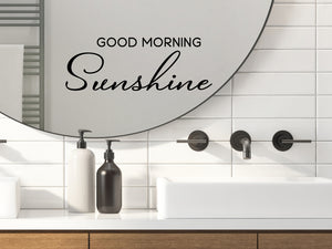 Wall decals for bathroom that say ‘Good Morning Sunshine’ in a script font on a bathroom mirror.