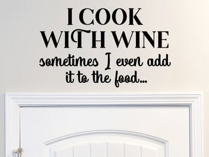 Decorative wall decal that says ‘I Cook With Wine Sometimes I Even Add It To The Food’ on a kitchen wall.