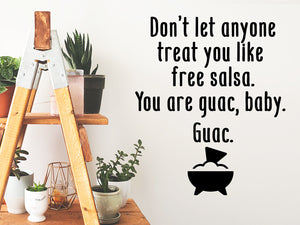 Wall decals for kitchen that say ‘Don't Let Anyone Treat You Like Free Salsa. You Are Guac, Baby. Guac.’ on a kitchen wall.