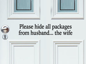 Front door decal that says, ‘Please Hide All Packages From Husband… The Wife’ in a print font on a front porch door.