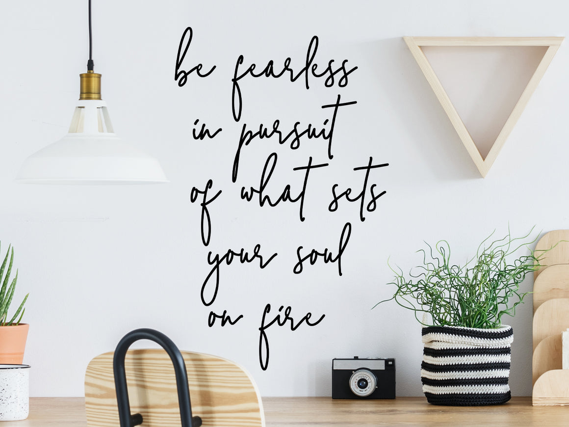 Decorative wall decal that says ‘Be Fearless In Pursuit Of What Sets Your Soul On Fire’ on an office wall.