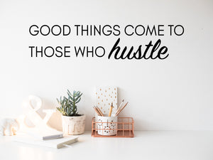 Wall decal for the office that says ‘Good Things Come To Those Who Hustle’ in a script font on an office wall.