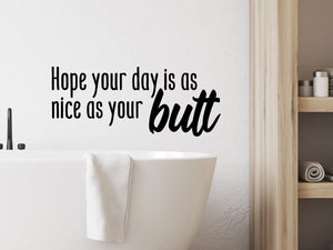 Wall decals for the bathroom that say, 'Hope your day is as nice as your butt' on a bathroom wall