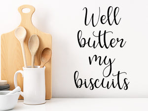Decorative wall decal that says ‘Well Butter My Biscuits’ on a kitchen wall.