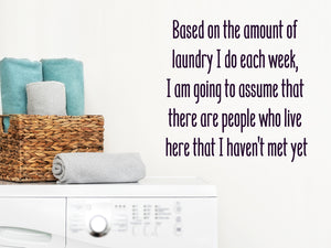Laundry room wall decal that says ‘Based On The Amount Of Laundry I Do Each Week I Am Going To Assume’ in a print font  on a laundry room wall