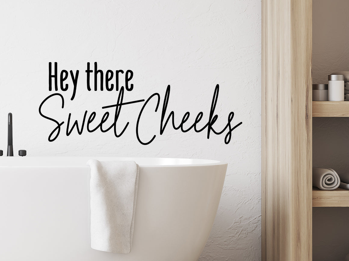 Wall decal for the bathroom that says ‘hello there sweet cheeks’ on a bathroom wall.