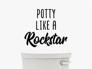 Wall decals for bathroom that say ‘potty like a rockstar’ on a bathroom wall.