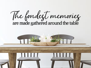 Wall decals for kitchen that say ‘The Fondest Memories Are Made Gathered Around The Table’ in a script font on a kitchen wall.