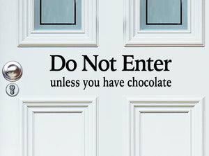 Front door decal that says, ‘Do Not Enter Unless You Have Chocolate’ on a front porch door. 