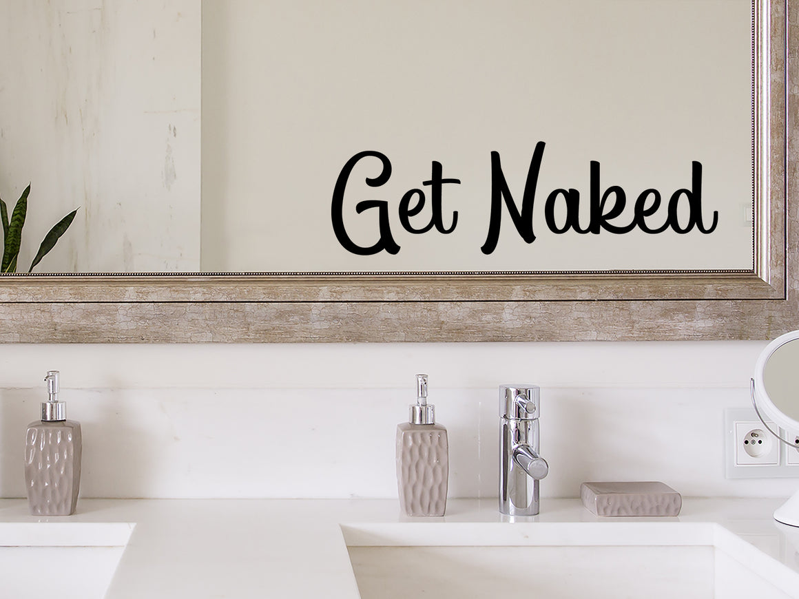 Wall decals for bathroom that say ‘Get Naked’ in a script font on a bathroom wall.