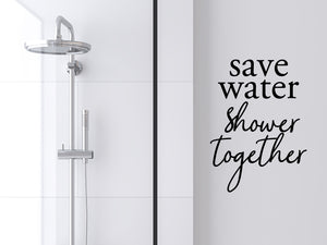 Wall decals for bathroom that say ‘Save Water Shower Together’ with a stack design on a bathroom wall.