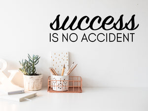 Wall decal for the office that says ‘Success Is No Accident’ in a script font on an office wall.