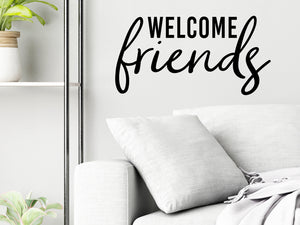 Living room wall decals that say ‘Welcome Friends’ in a bold font on a living room wall. 