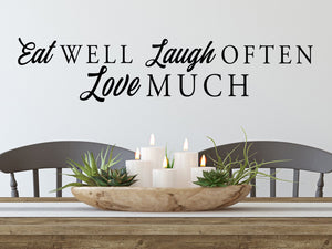 Wall decals for kitchen that say ‘eat well laugh often love much’ on a kitchen wall.