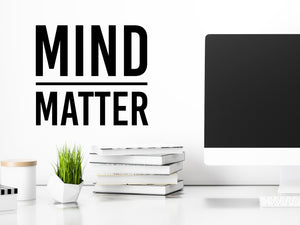 Decorative wall decal that says ‘Mind Over Matter’ on an office wall.