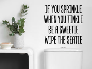 Wall decals for the bathroom that say 'If You Sprinkle When You Tinkle Be A Sweetie Wipe The Seatie' on a bathroom wall