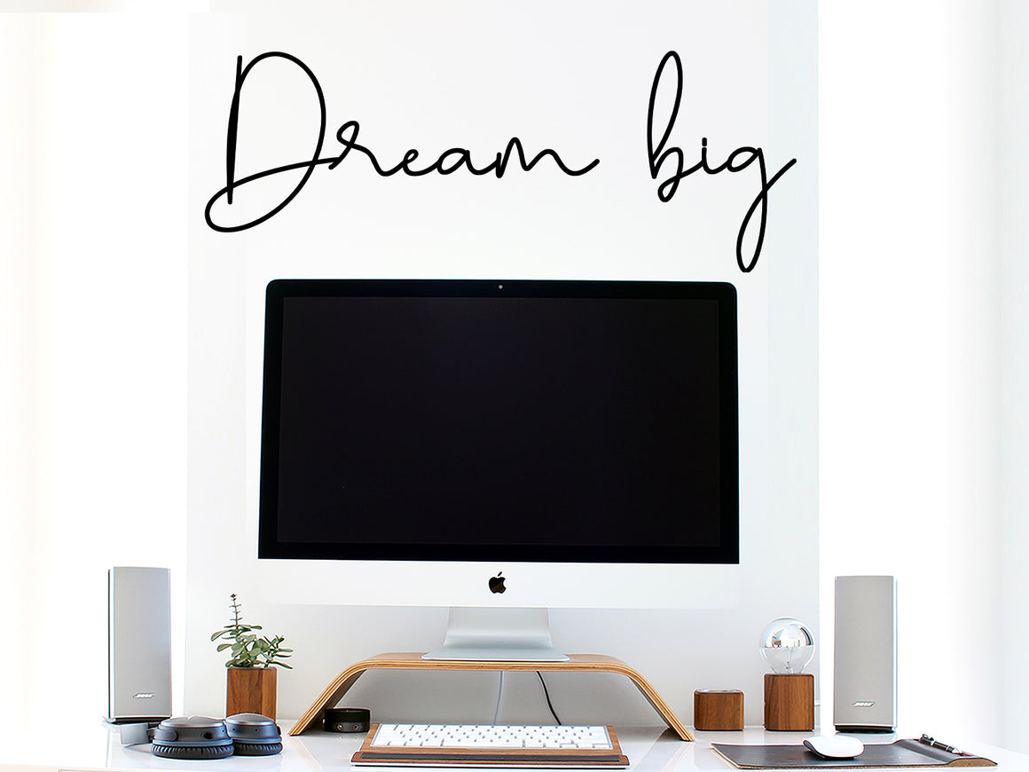 Decorative wall decal that says ‘Dream Big’ on an office wall.