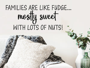 Living room wall decals that say ‘Families are like fudge...mostly sweet with lots of nuts!’ on a living room wall. 