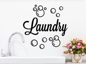 Laundry room wall decal that says ‘Laundry’ surrounded by bubbles on a laundry room wall.