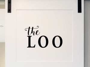 Wall decals for bathroom that say ‘the loo’ on a bathroom wall.