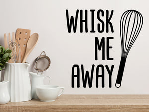 Decorative wall decal that says ‘Whisk Me Away’ on a kitchen wall.