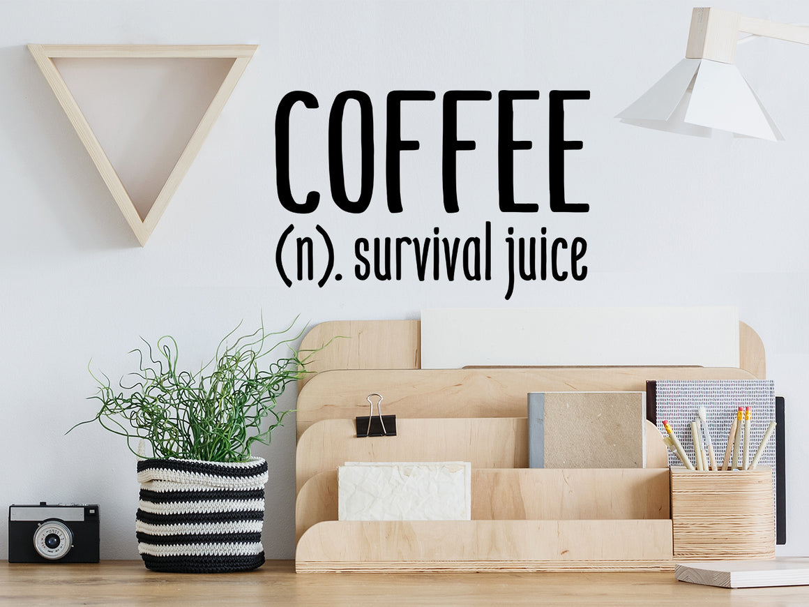 Decorative wall decal that says ‘Coffee Definition (Coffee: (n) Survival Juice)’ on an office wall.