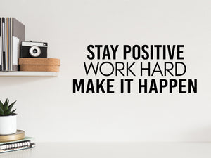 Wall decal for the office that says ‘Stay Positive Work Hard Make It Happen’ in a print font on an office wall.
