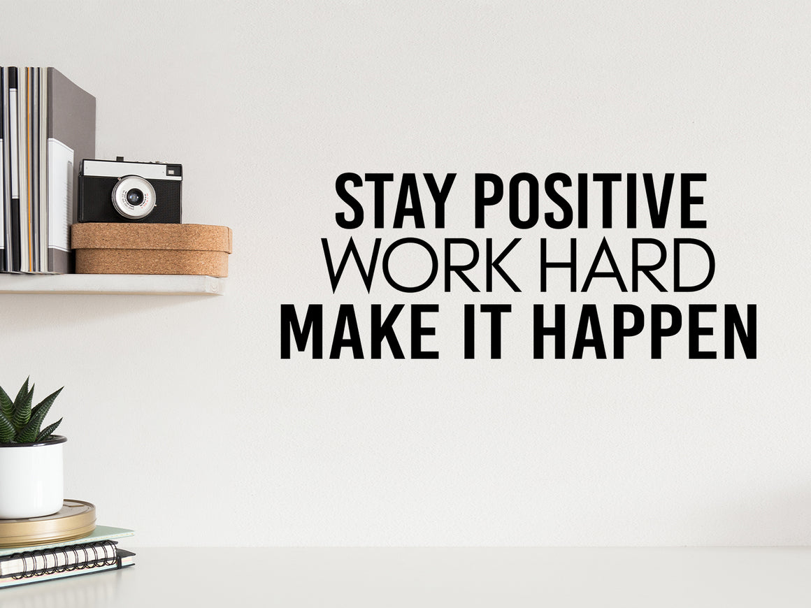 Wall decal for the office that says ‘Stay Positive Work Hard Make It Happen’ in a print font on an office wall.