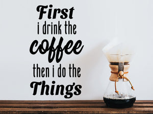 Wall decals for kitchen that say ‘first i drink the coffee then i do the things’ on a kitchen wall.