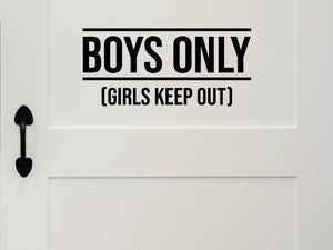 Wall decal for kids that says ‘Girls Keep Out Boys Only’ in a print font on a kid’s room wall. 