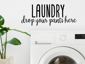 Laundry room wall decal that says ‘Laundry Drop Your Pants Here’ on a laundry room wall.