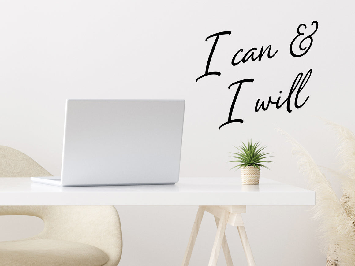 Wall decal for the office that says ‘I Can & I Will’ in a cursive font on an office wall.
