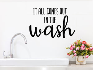 Laundry room wall decal that says ‘It All Comes Out In The Wash’ on a laundry room wall.