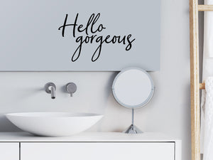 Wall decals for bathroom that say ‘Hello Gorgeous’ in a script font on a bathroom wall.