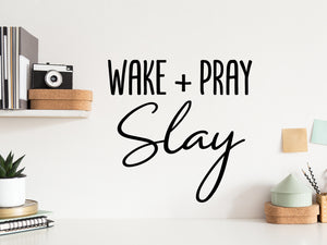 Wall decal for the office that says ‘Wake Pray Slay’ in a script font on an office wall.