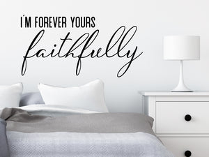 Wall decal for bedroom that says ‘I'm forever yours faithfully’ on a bedroom wall.