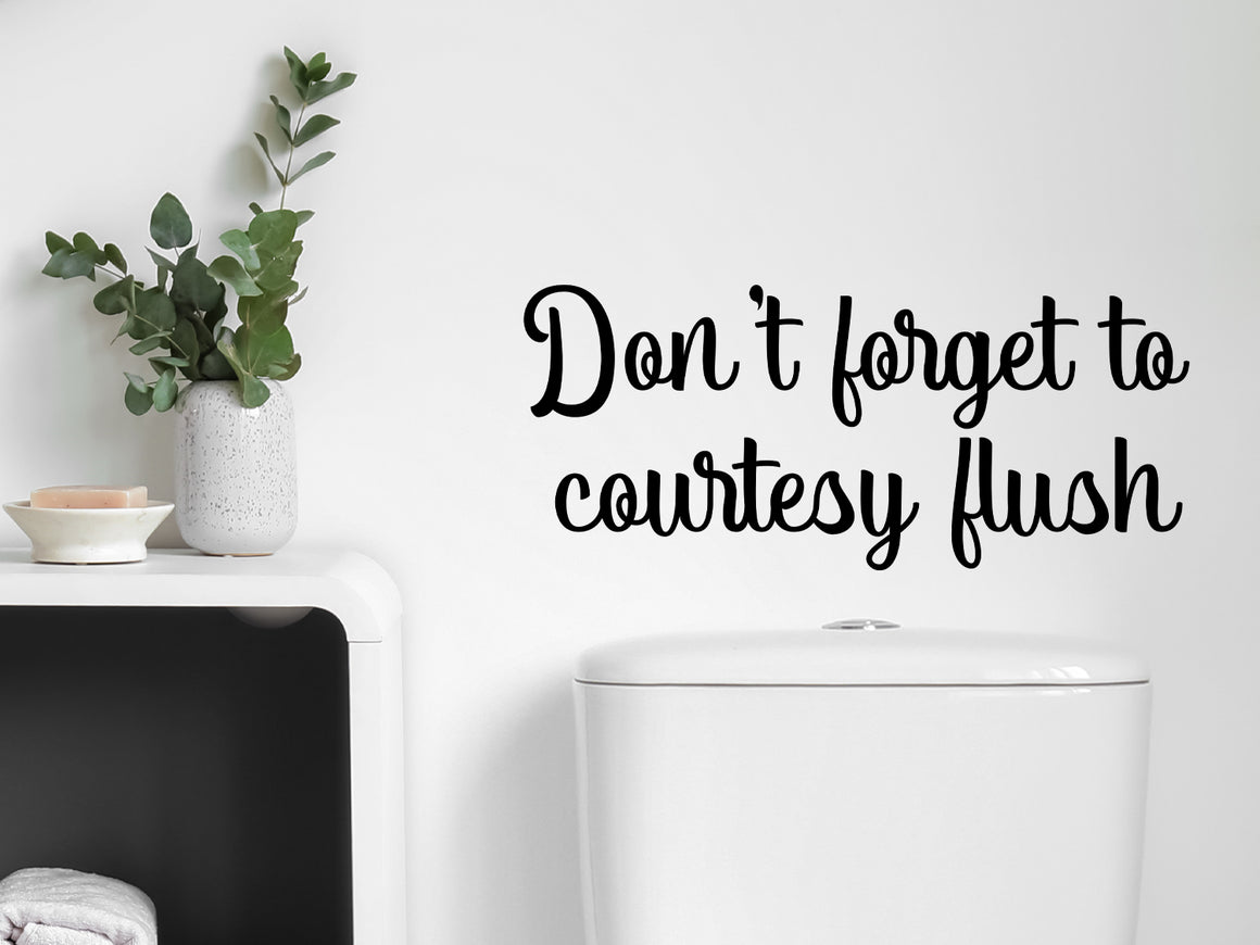 Wall decals for the bathroom that says ‘Don't Forget To Courtesy Flush’ on a bathroom wall.