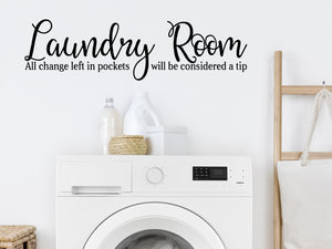 Laundry room wall decal that says ‘Laundry Room All Change Left In Pockets Will Be Considered A Tip’ on a laundry room wall.