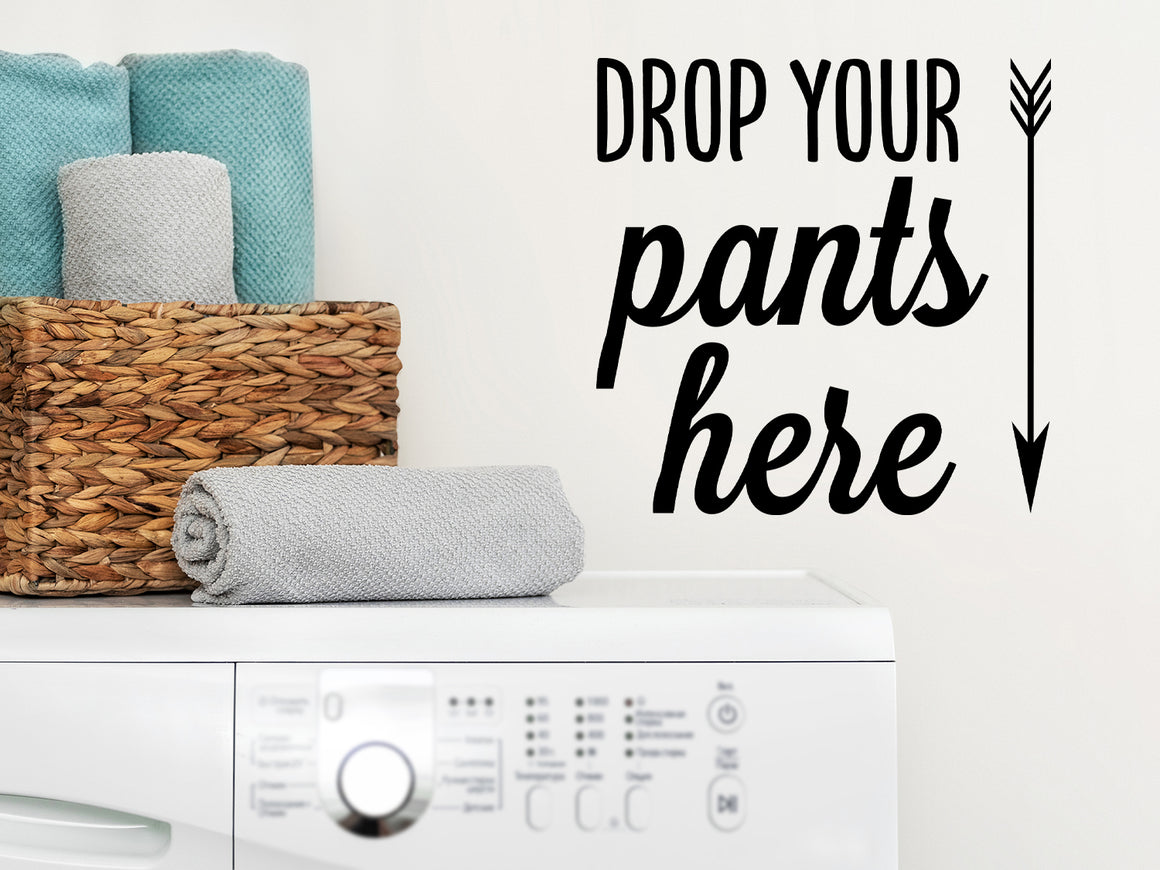 Laundry room wall decal that says ‘drop your pants here’ on a laundry room wall.
