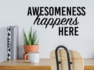 Wall decal for the office that says ‘Awesomeness Happens Here’ in a script font on an office wall.