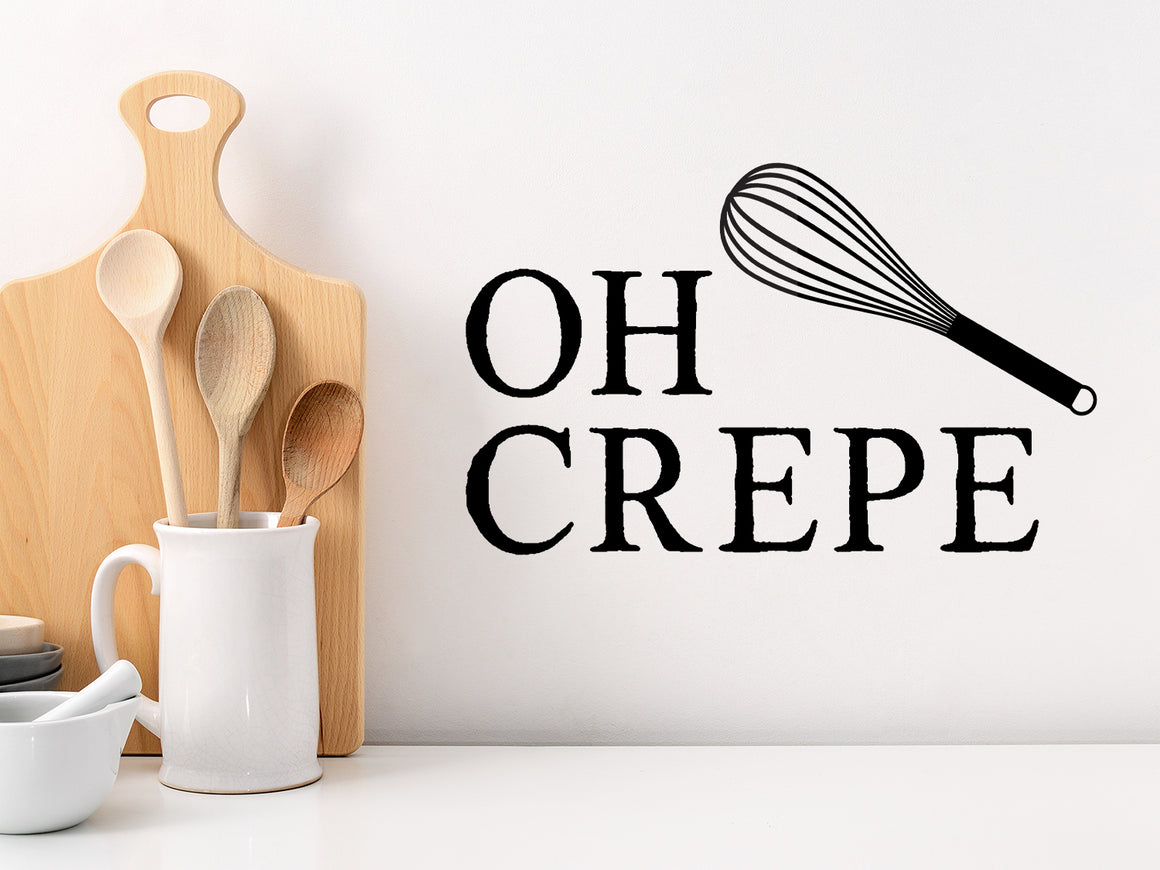 Decorative wall decal that says ‘Oh Crepe’ on a kitchen wall.