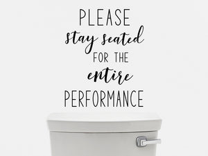 Wall decals for bathroom that say ‘please stay seated for the entire performance’ on a bathroom wall.