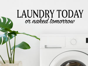 Laundry room wall decal that says ‘Laundry Today Or Naked Tomorrow’ on a laundry room wall.