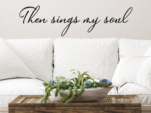 Living room wall decals that say ‘Then Sings My Soul’ in a cursive font on a living room wall. 