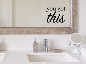 Wall decals for bathroom that say ‘You Got This’ in a bold font on a bathroom mirror.