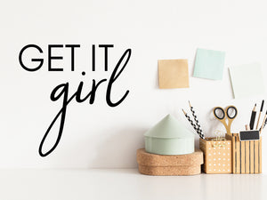 Wall decal for the office that says ‘Get It Girl’ in a script font on an office wall.